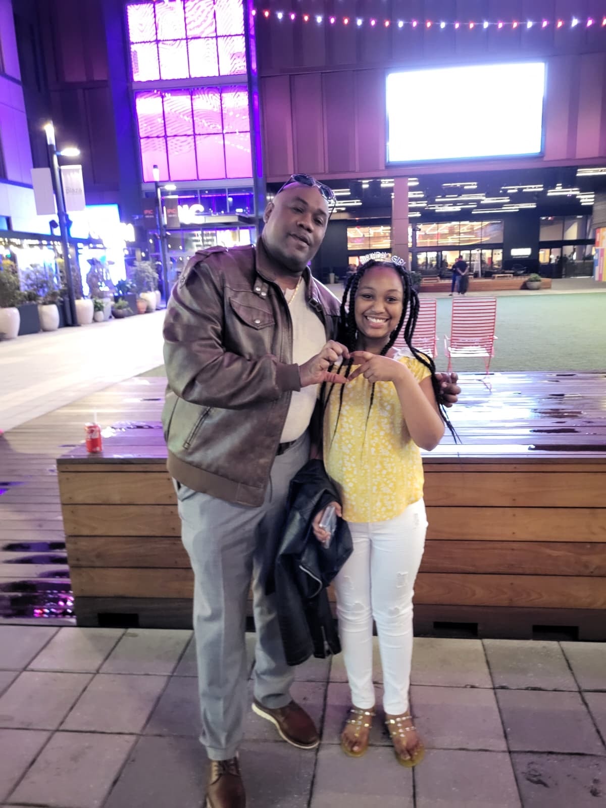 Anthony Robbins with his daughter at a night venue