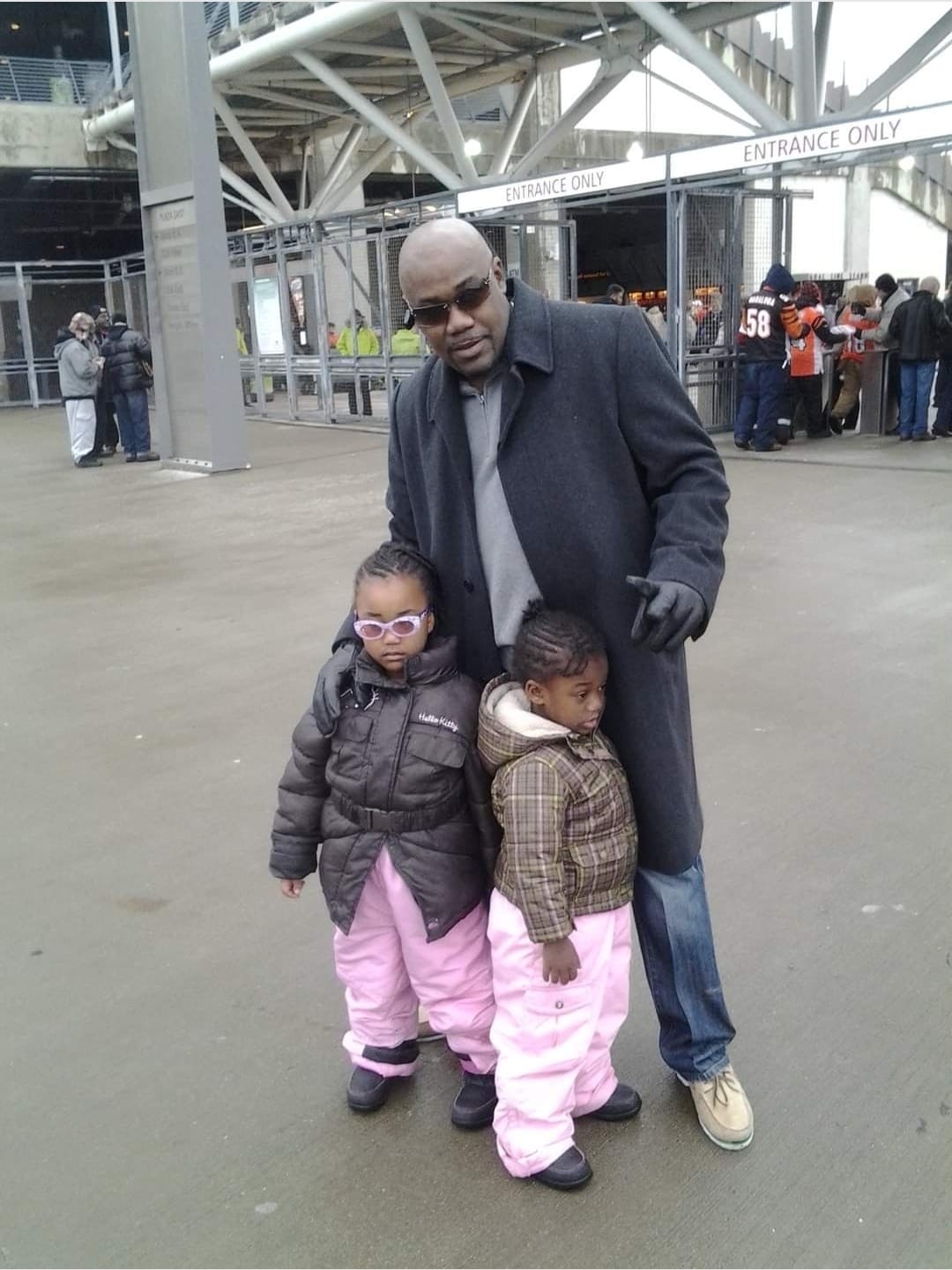 Anthony Robbins with his young children at a stadium